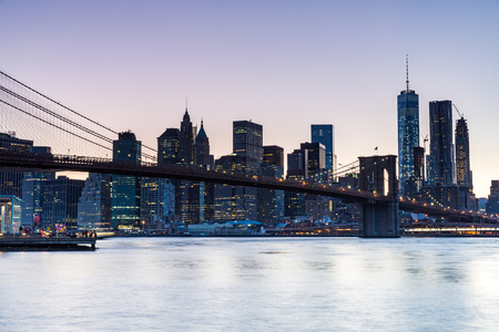 NEW YORK - AUGUST 22: Views of the Brooklyn Bridge on sunset on August 22, 2015. Its a famous and iconic bridge in New York, which passes the east river.のeditorial素材