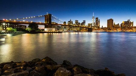 NEW YORK - AUGUST 22: Views of the Brooklyn Bridge on sunset on August 22, 2015. Its a famous and iconic bridge in New York, which passes the east river.のeditorial素材