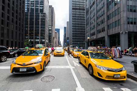 âNEW YORK - AUGUST 23: View to New Yorks taxicabs at the 5th Av on August 23, 2015. The taxicabs of New York City are widely recognized icons of the city, come in two varieties: yellow and green.のeditorial素材