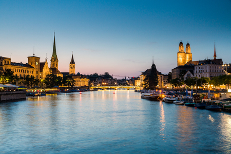ZURICH, SWITZERLAND - JULY 4: Famous postcard view of various houses and churches in the old town part of Zurich at sunset on July 4, 2015. Zurich is the biggest city in Switzerland.のeditorial素材