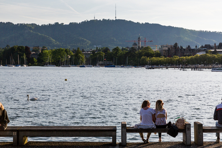 ZURICH, SWITZERLAND - MAY 17, 2015: View to the Mountain Uetliberg from the Zurich Lake promenade on May 17, 2015. Zurich is the biggest city in Switzerland.のeditorial素材