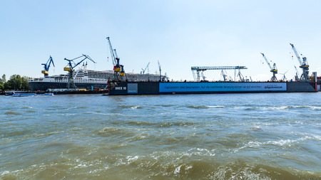 HAMBURG, GERMANY - JUNE 4, 2016: View of the Queen Mary 2 cruise ship in the port of Hamburg on June 4, 2016. Port of Hamburg is Germanys largest port and is named the countrys Gateway to the World.のeditorial素材