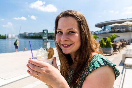 View of a girl eating ice cream at the Jungfernstieg in Hamburg, Germany