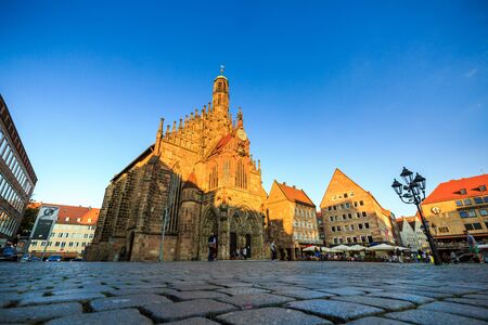 NURENBERG, GERMANY - JUNE 22, 2016: Exterior view of the Frauenkirche and historical building around in the old town part of Nurnberg on June 22, 2016. Its on the eastern side of the main marketのeditorial素材