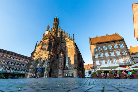 NURENBERG, GERMANY - JUNE 22, 2016: Exterior view of the Frauenkirche and historical building around in the old town part of Nurnberg on June 22, 2016. Its on the eastern side of the main marketのeditorial素材