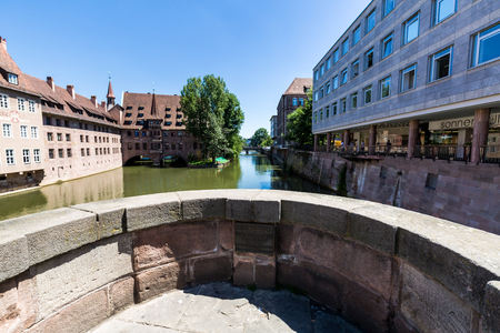 NUREMBERG, GERMANY - JUNE 23, 2016: View from a historical arch bridge called Museumsbrucke to the Heilig Geist Hospital in the old town part of Nurnberg on June 23, 2016.のeditorial素材