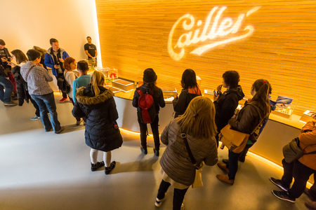 BROC, SWITZERLAND - MAY 1, 2017: People are trying chocolate at the Cailler factory tour in Broc on...