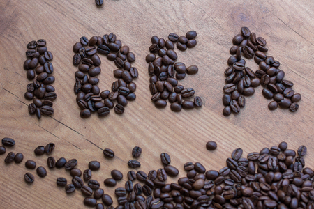 Idea concept sign drawn among brown well roasted coffee beansの写真素材