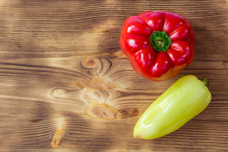Vegetable background for postcard with two red and green peppers on wooden boardの写真素材