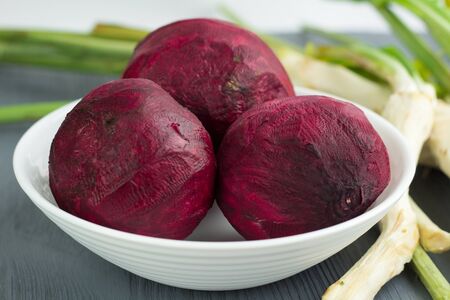 Still life of prepared cleaned raw vegetables beetroot and horseredish for borsch beet soup of russian cuisine on grey wooden backgroundの写真素材