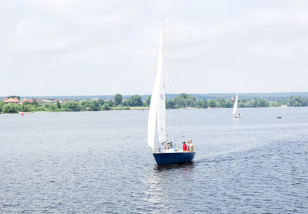 Sailboat yacht team sailing with full sails  on river lakeのeditorial素材