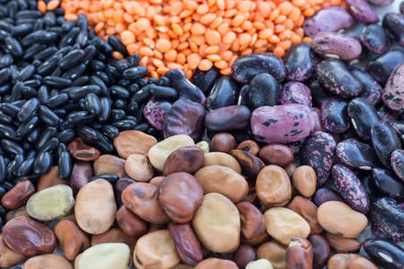 Multicolored background of healthy organic vegan grain food cereal bean lentils ingredients mixの写真素材