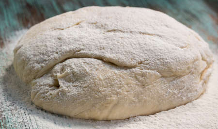 Fresh dough mixed and kneaded from white wheat flour during bakingの写真素材