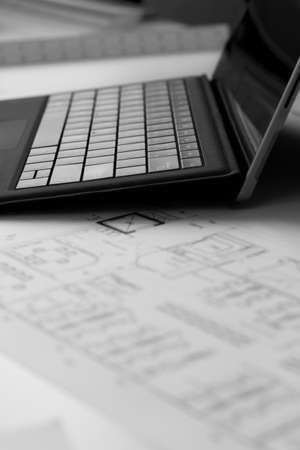 Notebook for work and construction drawing paper in gray tones.
Picture of a laptop on a desk in a construction companyの写真素材