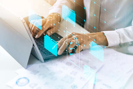 Entrepreneurs check documents for doing business with partners.,Employees opening data files in the...