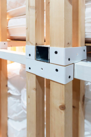 Steel holds a square timber structure in place.