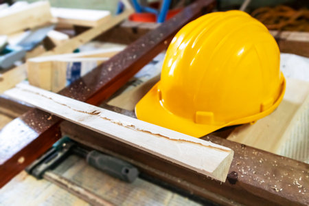 Construction worker tools and a hard hat on a wooden table.safety in work