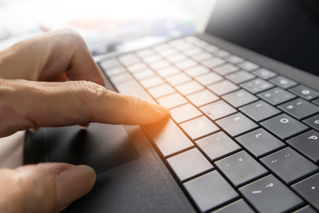 Hand pressing laptop buttons,Deciding on a business path