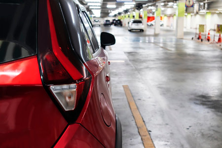 Parking lot: red four-seater vehicle a side view of the vehicle's backの写真素材