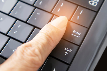 Hand pressing laptop buttons,Deciding on a business path