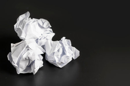 White paper crumpled against a black background The idea doesn't make sense, it doesn't work, and it doesn't work well.の写真素材