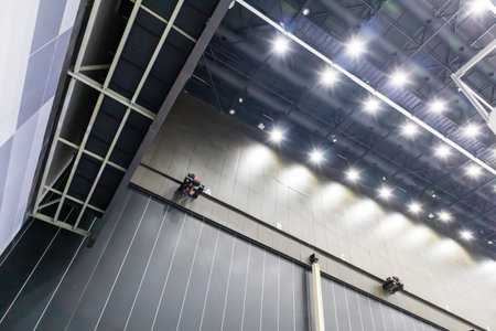 A huge hall the size of a building with a steel ceiling construction. Install illumination...