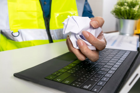 Construction and system engineers sit in their offices and crumple papers, dissatisfied with poor...