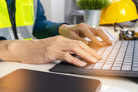 Construction and system engineers sit in their offices and draw up construction and system drawings.の写真素材