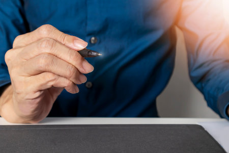 Starting business, capturing key points in mind. ,Businessman grabbing pen to point out work direction and advice.の写真素材