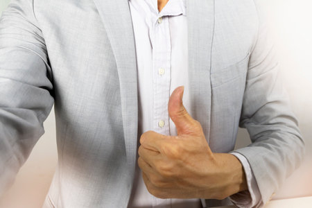 Executives give a thumbs up to show appreciation and encouragement for their work.の写真素材