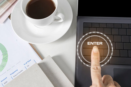 Hand pressing laptop buttons,Deciding on a business pathの写真素材
