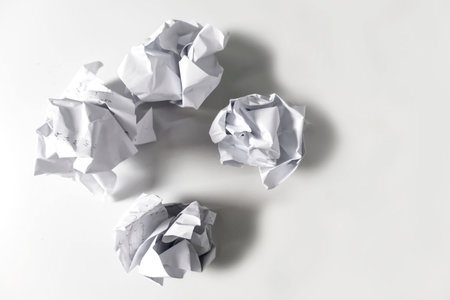 Crumpled white paper on a white background.