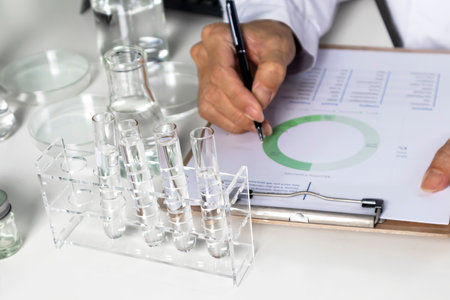 Researchers study data and experiment with chemicals, scientific process, record results and report...