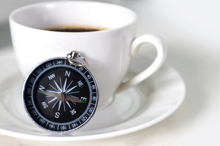 Compass and Coffee Cups for Travel Stories and Direction in Life Telling Stories of the Past