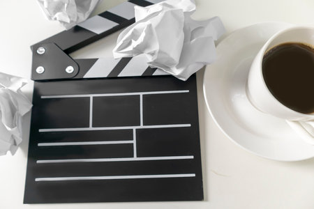 Director's board and crumpled paper on a white background. Thinking about how to create a story.