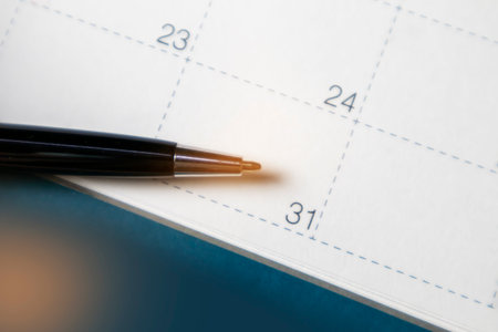 Black business pen on calendar background. Appointment planning work schedule.の写真素材