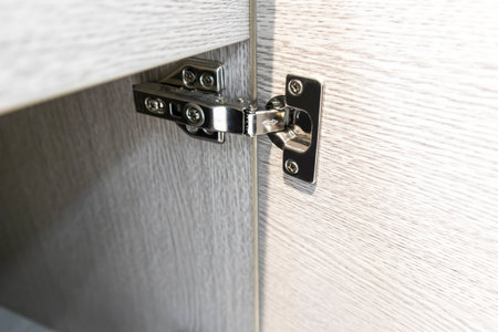Details of hinges on wooden cabinet doors in interior designの写真素材