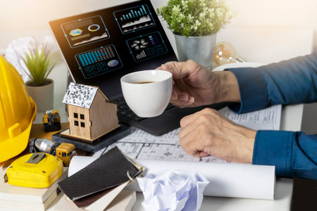 Engineers work on construction drawings and safety systems.,Building construction puts safety first.の写真素材