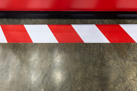 Red and white stripes on concrete walls to warn of dangerous areasの写真素材