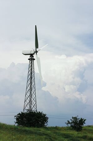 Landscape with hills and wind turbines. cloudy sky