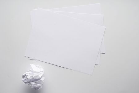 clean sheets of paper and crumpled piece on a white backgroundの写真素材
