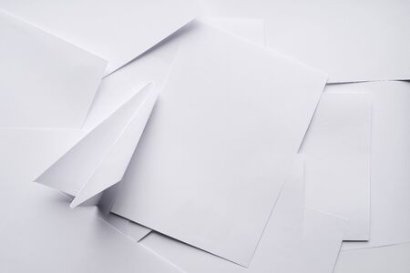 White paper planes on a background sheet of office paper. Origamiの写真素材