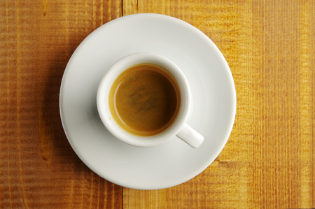 A cup of fragrant coffee on a rough board. top viewの写真素材