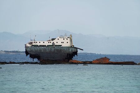 Wrecked boat abandoned stand on reef or Shipwreckedの写真素材
