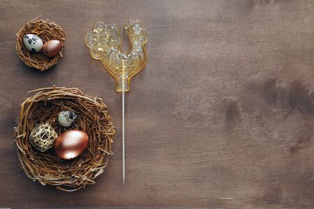 Easter eggs and decorative ornaments on a wooden background. Template for postcard, congratulations,...