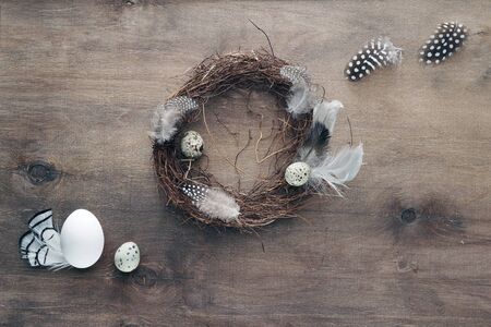 Easter eggs and decorative ornaments on a wooden background. Template for postcard, congratulations,...