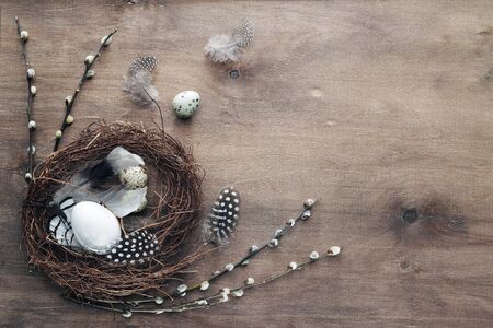 Easter eggs and decorative ornaments on a wooden background. Template for postcard, congratulations,...