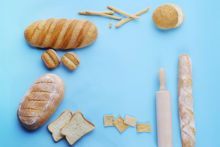 decorative display of wheat baking and kitchen accessories on a light blue background, top viewの写真素材