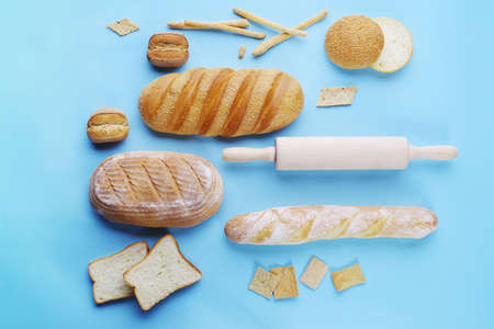 decorative display of wheat baking and kitchen accessories on a light blue background, top viewの写真素材