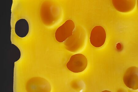 A close-up of a cheese texture with holes.の写真素材
